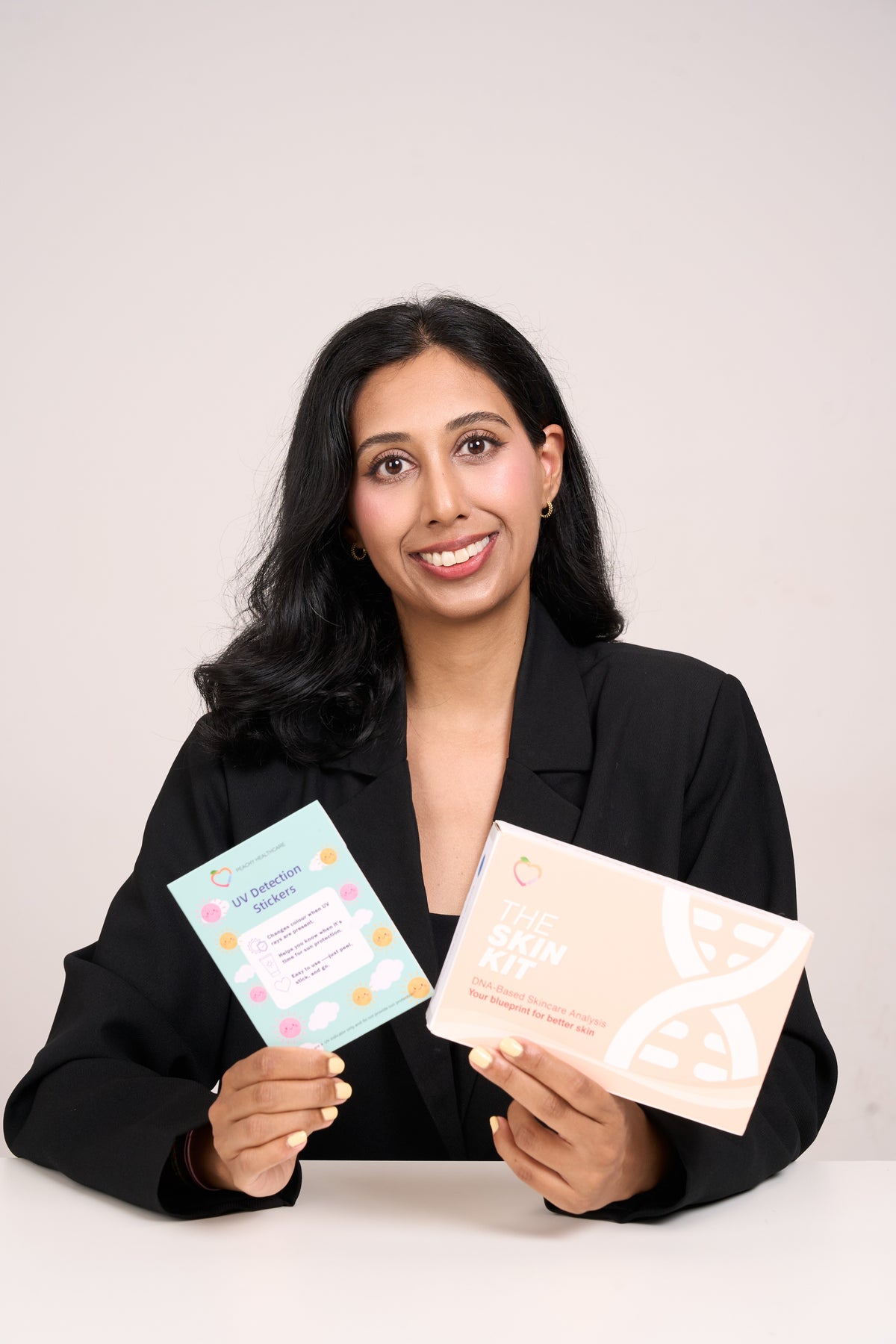 Dr Yasmin Karsan, pharmacist and founder of Peachy Healthcare, holding The Skin Kit
